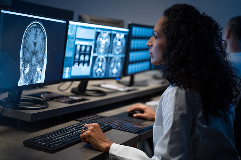 Doctor reviews a brain scan on a computer monitor