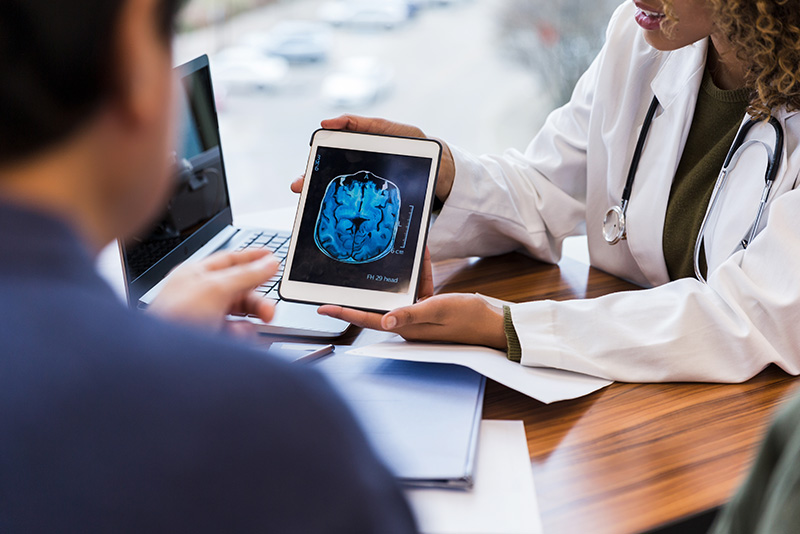 Doctor discussing brain scan imagery with patient