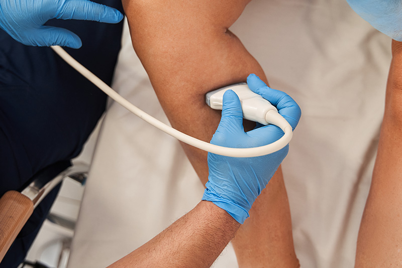 Patient receiving ultrasound of their lower leg