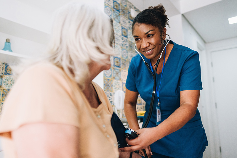 Medical Assistant take a woman's blood pressure