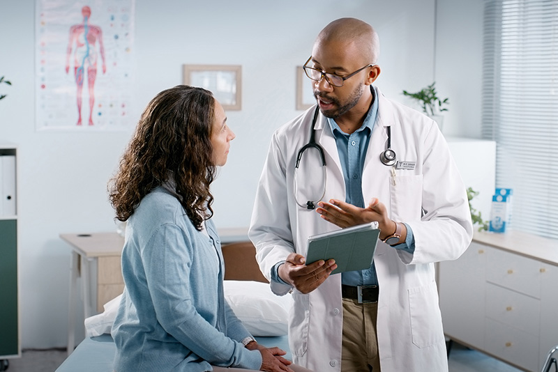 Doctor having a discussion with a patient in an exam room