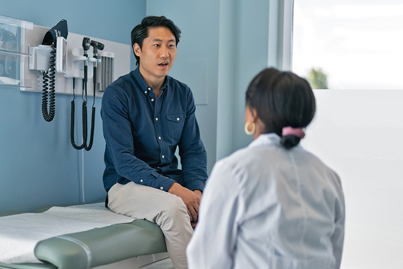 Patient having a discussion with his doctor in an exam room