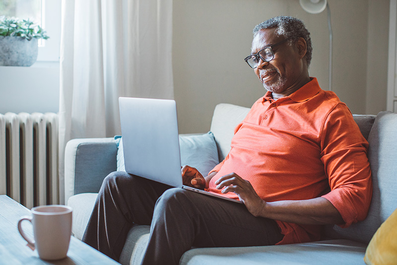 Senior person viewing the medical info on their laptop at home