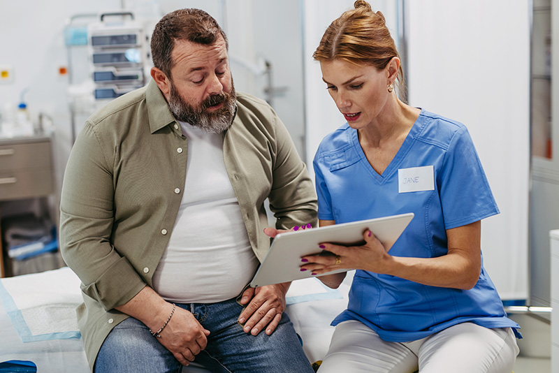 Overweight man speaks with doctor